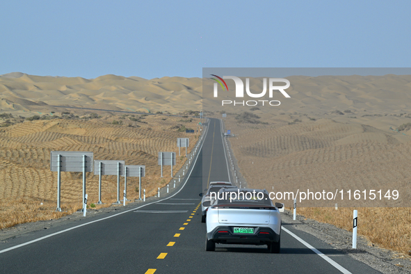 Vehicles drive on a desert highway in Bazhou, Xinjiang province, China, on September 23, 2024. 