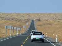 Vehicles drive on a desert highway in Bazhou, Xinjiang province, China, on September 23, 2024. (