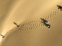 Tourists visit the ''Langsha Mountain'' scenic spot section of the desert highway in Bazhou, Xinjiang, China, on September 23, 2024. (