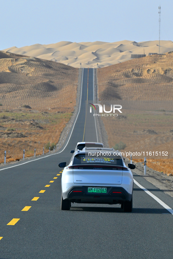 Vehicles drive on a desert highway in Bazhou, Xinjiang province, China, on September 23, 2024. 