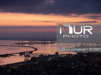 Dawn breaks over the northern Israeli port city of Haifa, in Israel, on September 28, 2024, one day following large-scale Israeli air strike...