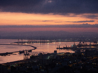 Dawn breaks over the northern Israeli port city of Haifa, in Israel, on September 28, 2024, one day following large-scale Israeli air strike...