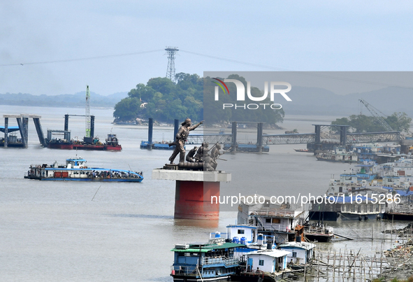 People ride in a ferry on the Brahmaputra River in Guwahati, India, on September 28, 2024. 