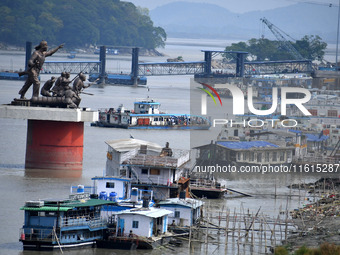 People ride in a ferry on the Brahmaputra River in Guwahati, India, on September 28, 2024. (