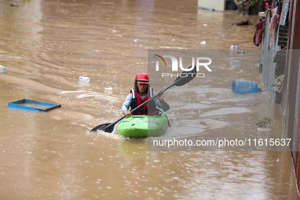 A Nepal Army personnel wades through a flooded area in search of stranded and trapped people using a kayak in Kathmandu, Nepal, on September...