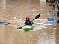 A Nepal Army personnel wades through a flooded area in search of stranded and trapped people using a kayak in Kathmandu, Nepal, on September...