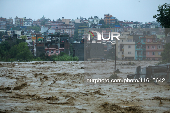 The swollen Nakkhu River inundates infrastructures built on its embankments in Lalitpur, Nepal, on September 28, 2024. At least 32 people di...