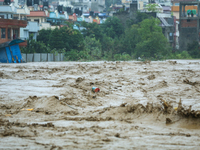 The swollen Nakkhu River inundates infrastructures built on its embankments in Lalitpur, Nepal, on September 28, 2024. At least 32 people di...