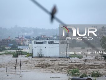 The swollen Nakkhu River inundates infrastructures built on its embankments in Lalitpur, Nepal, on September 28, 2024. At least 32 people di...