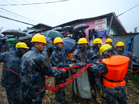 Nepal's Armed Police Force personnel prepare for a rescue operation to bring out a stranded person from a flooded river in Lalitpur, Nepal,...