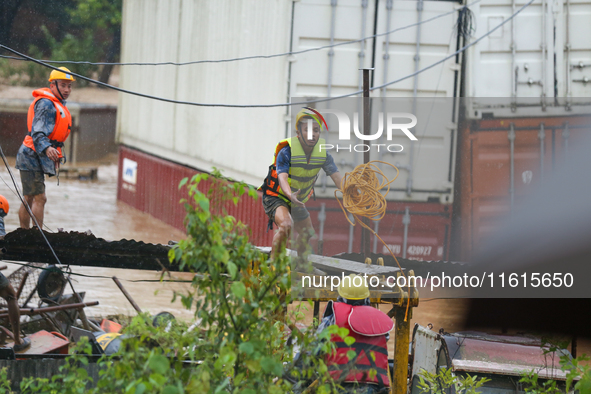 Nepal's Armed Police Force personnel prepare for a rescue operation to bring out a stranded person from a flooded river in Lalitpur, Nepal,...