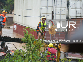 Nepal's Armed Police Force personnel prepare for a rescue operation to bring out a stranded person from a flooded river in Lalitpur, Nepal,...