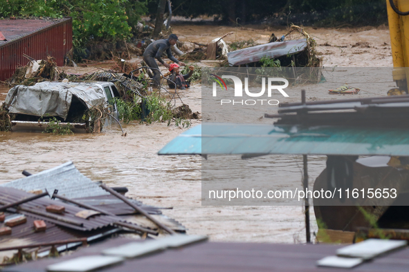 Nepal's Armed Police Force personnel rescue a stranded person from a flooded river in Lalitpur, Nepal, on September 28, 2024. At least 32 pe...