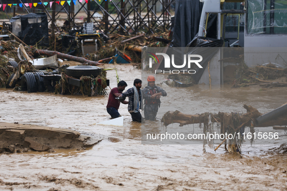 Nepal's Armed Police Force personnel rescue stranded people from a flooded river in Lalitpur, Nepal, on September 28, 2024. At least 32 peop...