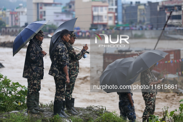 Security personnel of Nepal's security agencies carry out the rescue operation in Lalitpur, Nepal, on September 28, 2024. At least 32 people...