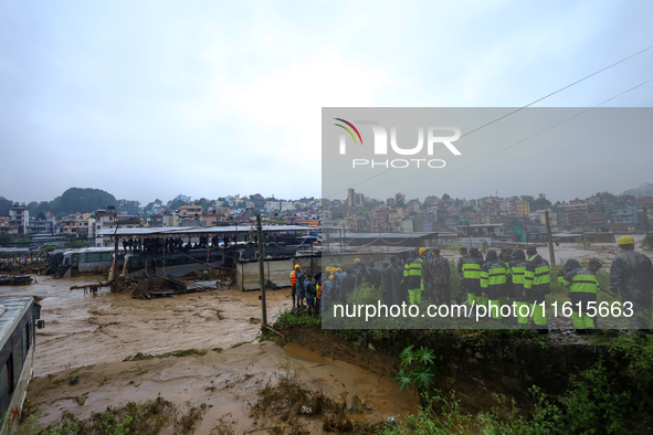 Nepal's Armed Police Force rescues stranded people using a zipline rescue method from a flooded river in Lalitpur, Nepal, on September 28, 2...