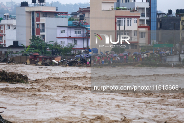 A swollen river inundates infrastructures built on its embankments in Lalitpur, Nepal, on September 28, 2024. At least 32 people die in the...