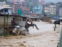 Nepal's Armed Police Force rescues stranded people using a zipline rescue method from a flooded river in Lalitpur, Nepal, on September 28, 2...