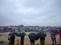 People watch the swollen and flooded Nakkhu River in City, Country, on September 28, 2024. At least 32 people die in the last 24 hours due t...