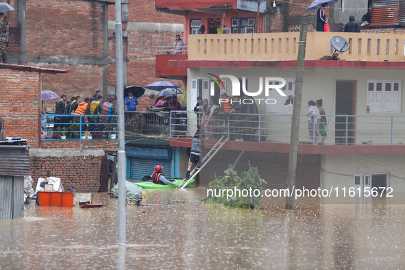 The Nepal Army conducts a rescue operation after a house is inundated by the swollen Bagmati River in Kathmandu, Nepal, on September 28, 202...