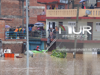 The Nepal Army conducts a rescue operation after a house is inundated by the swollen Bagmati River in Kathmandu, Nepal, on September 28, 202...