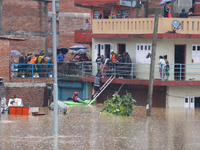 The Nepal Army conducts a rescue operation after a house is inundated by the swollen Bagmati River in Kathmandu, Nepal, on September 28, 202...