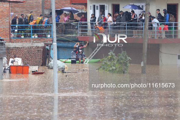 The Nepal Army conducts a rescue operation after a house is inundated by the swollen Bagmati River in Kathmandu, Nepal, on September 28, 202...