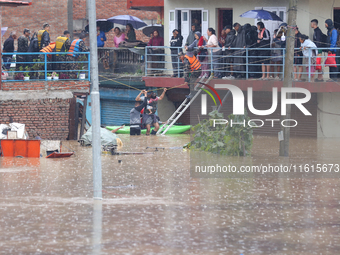 The Nepal Army conducts a rescue operation after a house is inundated by the swollen Bagmati River in Kathmandu, Nepal, on September 28, 202...