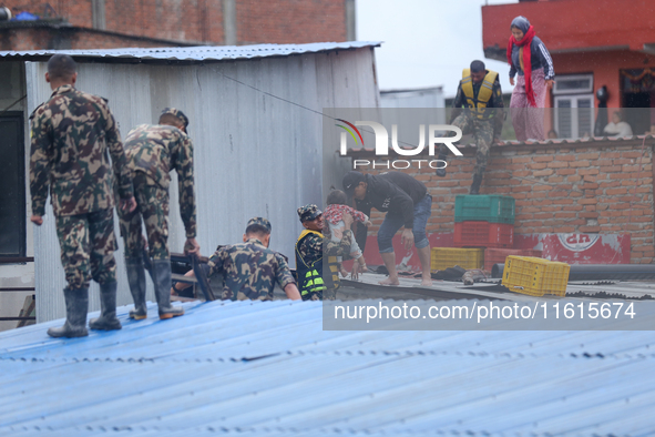 The Nepal Army conducts a rescue operation after a house is inundated by the swollen Bagmati River in Kathmandu, Nepal, on September 28, 202...