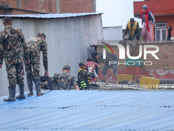 The Nepal Army conducts a rescue operation after a house is inundated by the swollen Bagmati River in Kathmandu, Nepal, on September 28, 202...