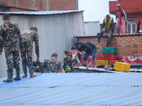 The Nepal Army conducts a rescue operation after a house is inundated by the swollen Bagmati River in Kathmandu, Nepal, on September 28, 202...