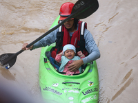 A Nepal Army personnel evacuates an infant using a kayak from a flooded residential area in Kathmandu, Nepal, on September 28, 2024. At leas...