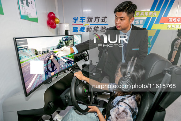 Students learn driving skills on an AI simulator at Landun Smart Driving School in Hua County, Anyang, China, on September 28, 2024. 