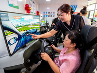 Students learn driving skills on an AI simulator at Landun Smart Driving School in Hua County, Anyang, China, on September 28, 2024. (