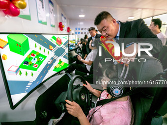 Students learn driving skills on an AI simulator at Landun Smart Driving School in Hua County, Anyang, China, on September 28, 2024. (