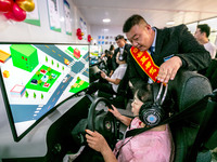 Students learn driving skills on an AI simulator at Landun Smart Driving School in Hua County, Anyang, China, on September 28, 2024. (