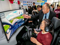 Students learn driving skills on an AI simulator at Landun Smart Driving School in Hua County, Anyang, China, on September 28, 2024. (