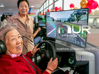 A 93-year-old grandmother learns driving skills on an AI intelligent simulator at the Blue Shield Intelligent Driving School in Huaxian Coun...