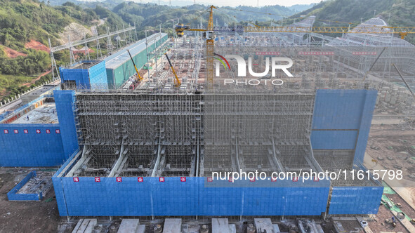 Construction workers work at the construction site of the 800 kV Yubei converter station in Chongqing, China, on September 28, 2024. 