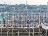 Construction workers work at the construction site of the 800 kV Yubei converter station in Chongqing, China, on September 28, 2024. (