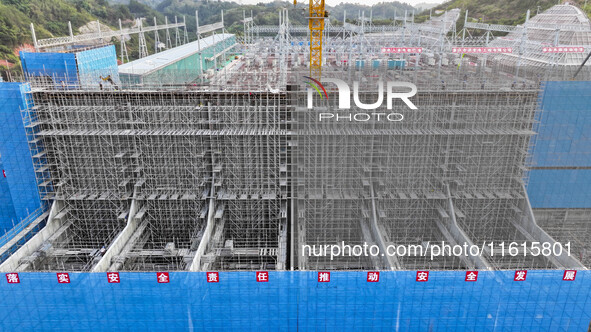 Construction workers work at the construction site of the 800 kV Yubei converter station in Chongqing, China, on September 28, 2024. 