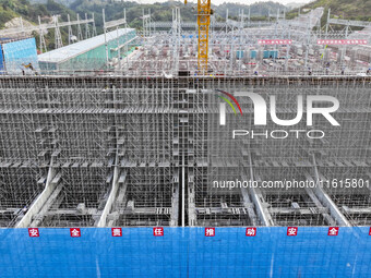 Construction workers work at the construction site of the 800 kV Yubei converter station in Chongqing, China, on September 28, 2024. (