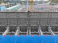 Construction workers work at the construction site of the 800 kV Yubei converter station in Chongqing, China, on September 28, 2024. (