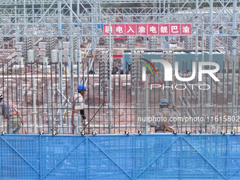 Construction workers work at the construction site of the 800 kV Yubei converter station in Chongqing, China, on September 28, 2024. (