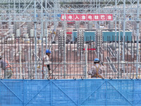 Construction workers work at the construction site of the 800 kV Yubei converter station in Chongqing, China, on September 28, 2024. (