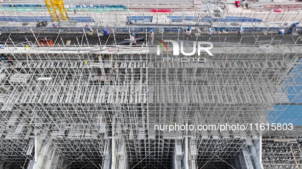 Construction workers work at the construction site of the 800 kV Yubei converter station in Chongqing, China, on September 28, 2024. 