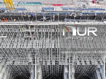 Construction workers work at the construction site of the 800 kV Yubei converter station in Chongqing, China, on September 28, 2024. (