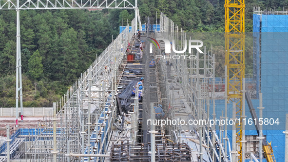 Construction workers work at the construction site of the 800 kV Yubei converter station in Chongqing, China, on September 28, 2024. 