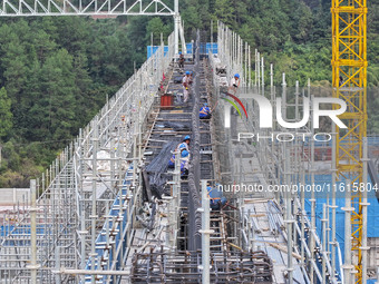 Construction workers work at the construction site of the 800 kV Yubei converter station in Chongqing, China, on September 28, 2024. (