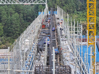 Construction workers work at the construction site of the 800 kV Yubei converter station in Chongqing, China, on September 28, 2024. (